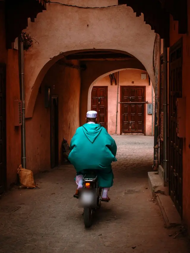 A rider under a gate of the Marrakech medina